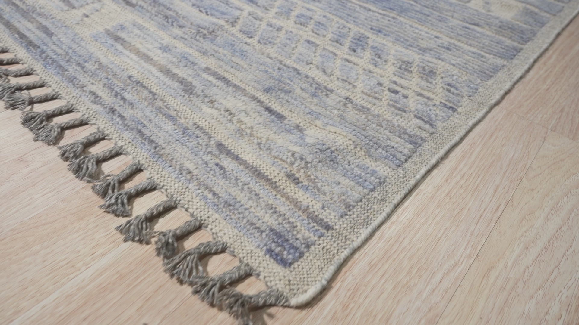 Here's the alt text based on the provided information:
 
 Classic Marrakech Blue Hand-Knotted Wool Rug, showcasing its vibrant blue hues and intricate hand-knotted wool construction, nestled elegantly within a room setting, demonstrating its scale and design within a living space.