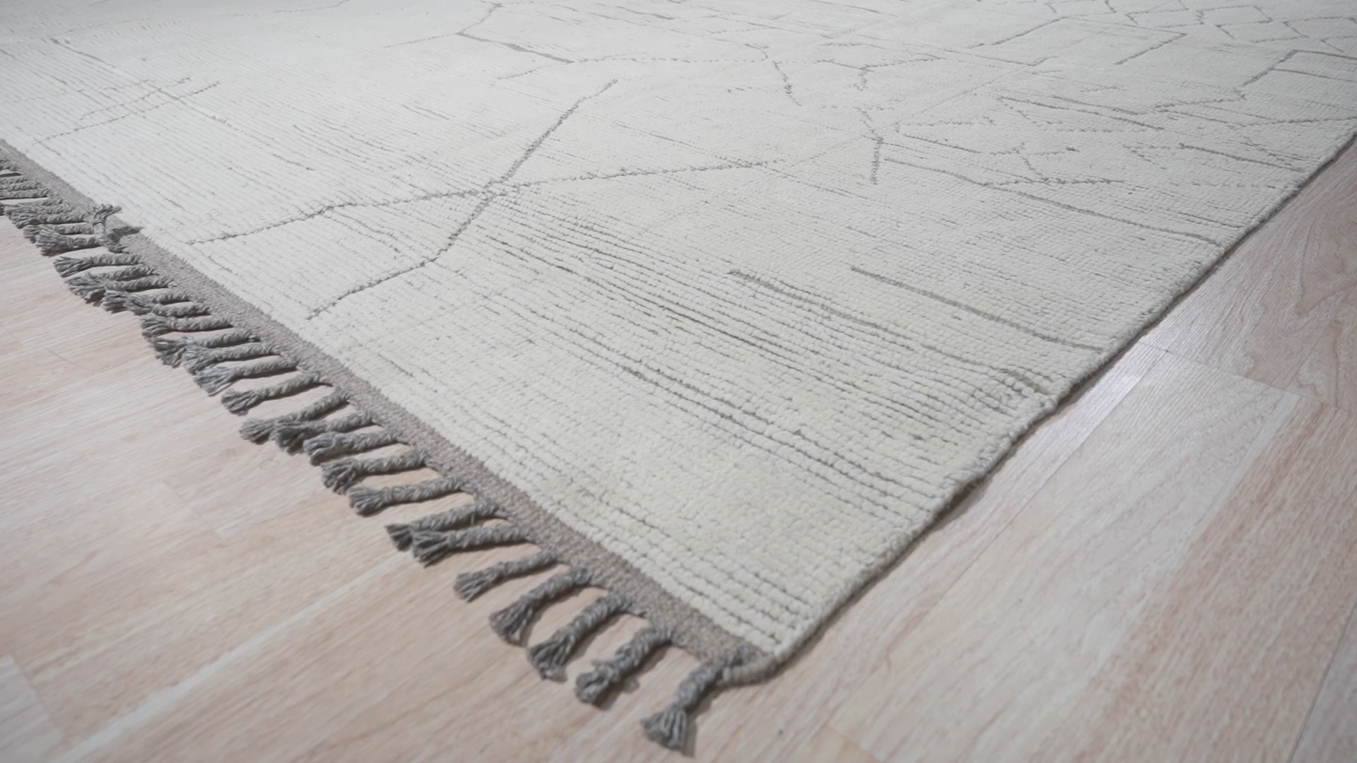 Marrakech Serenity Ivory Rug, blending seamlessly into a bright living room scene. Woven texture and subtle geometric patterns create a serene and inviting atmosphere.