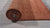 Given the image position is 12, the alt text should be:
 
 "Jasmine Alluring Orange Handmade Wool Rug, a vibrant orange wool rug likely within a styled room setting, showcasing its construction and color."