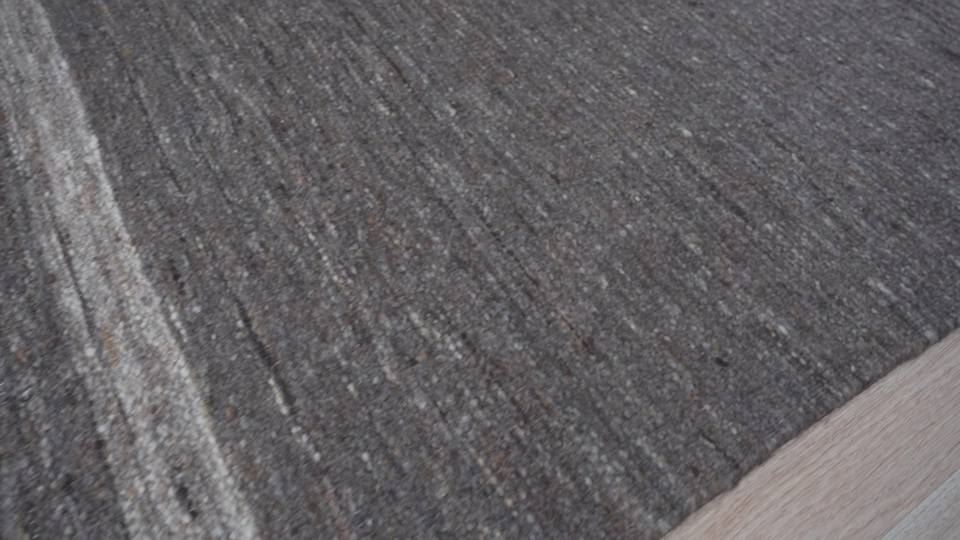 Cozy Inviting Gray Flatweave Wool Rug, subtle gray tones blend seamlessly within a minimalist living space, offering warmth and texture underfoot.