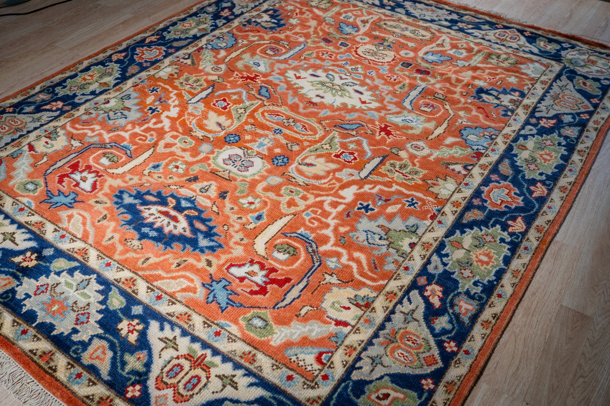 Rust Oushak floral wool rug, angled full view