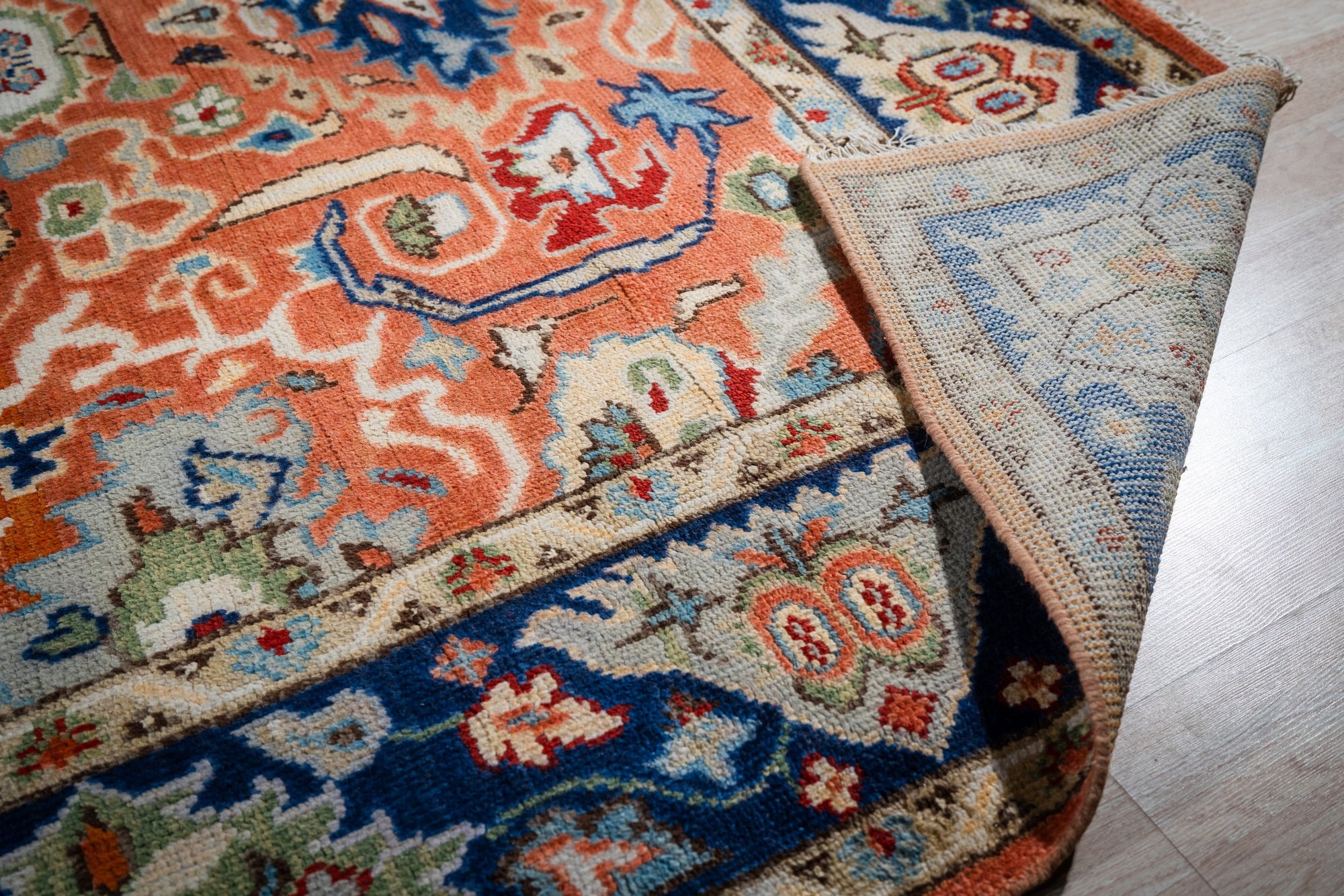 Rust Oushak rug back and navy border detail