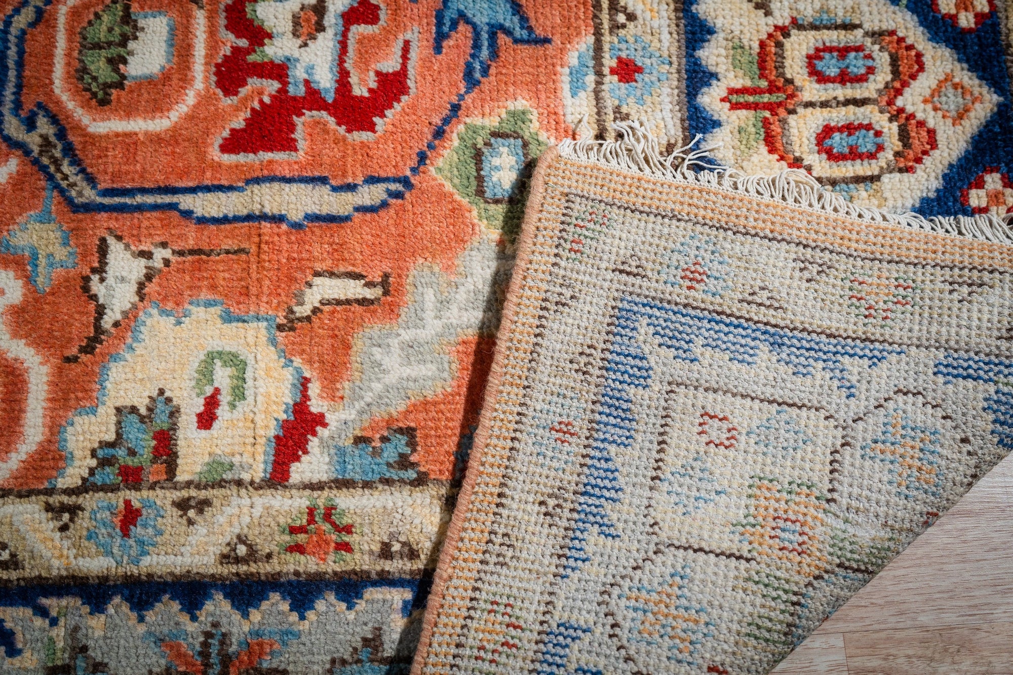 Rust Oushak rug corner folded showing the back