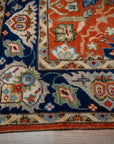 Rust Oushak rug corner and navy border detail