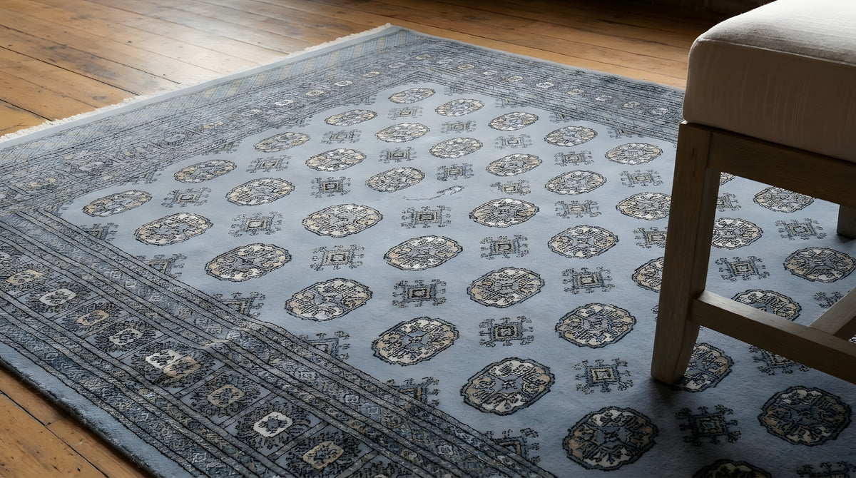 Rustic Nina Gray Hand Knotted Wool Rug in a reading nook
