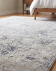 Sumptuous Lila Beige and Gray Machine Made Wool Rug in a bedroom