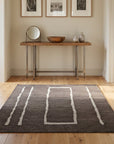 Talia Delicate Brown Flatweave Wool Rug in a hallway