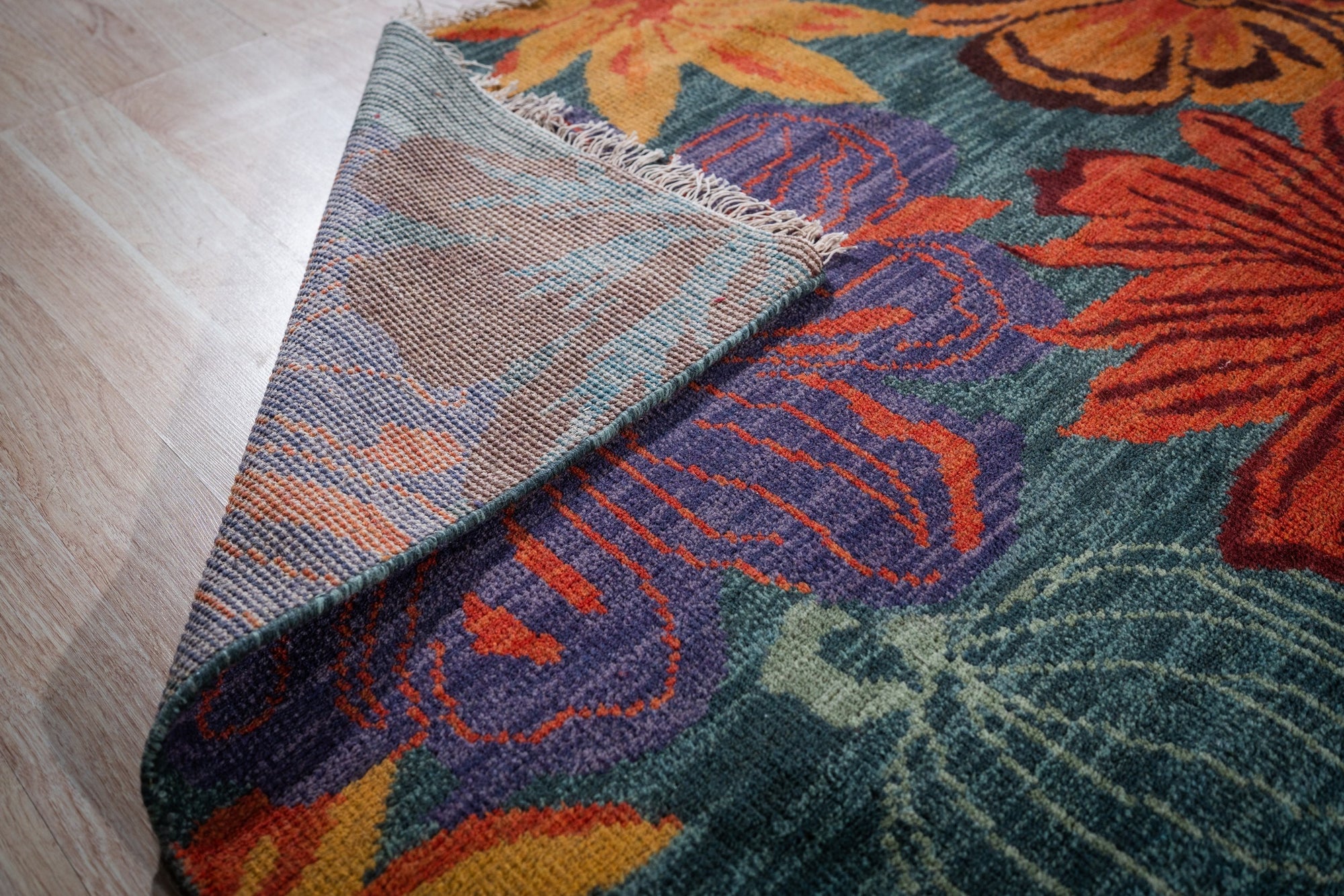 Teal contemporary floral rug back corner detail