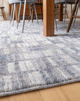 Tessa Sophisticated Gray Hand Knotted Wool Rug in a dining room