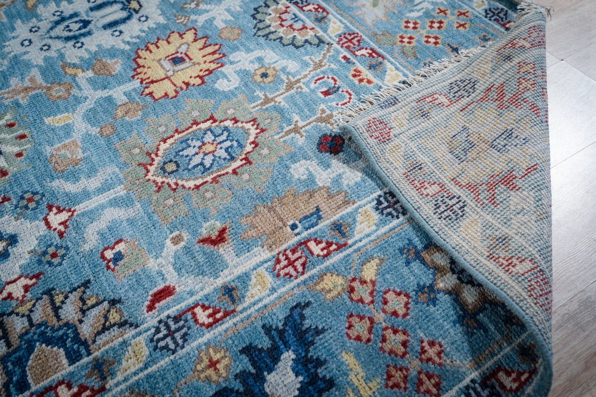 Turquoise Oushak rug field and hand-knotted back detail