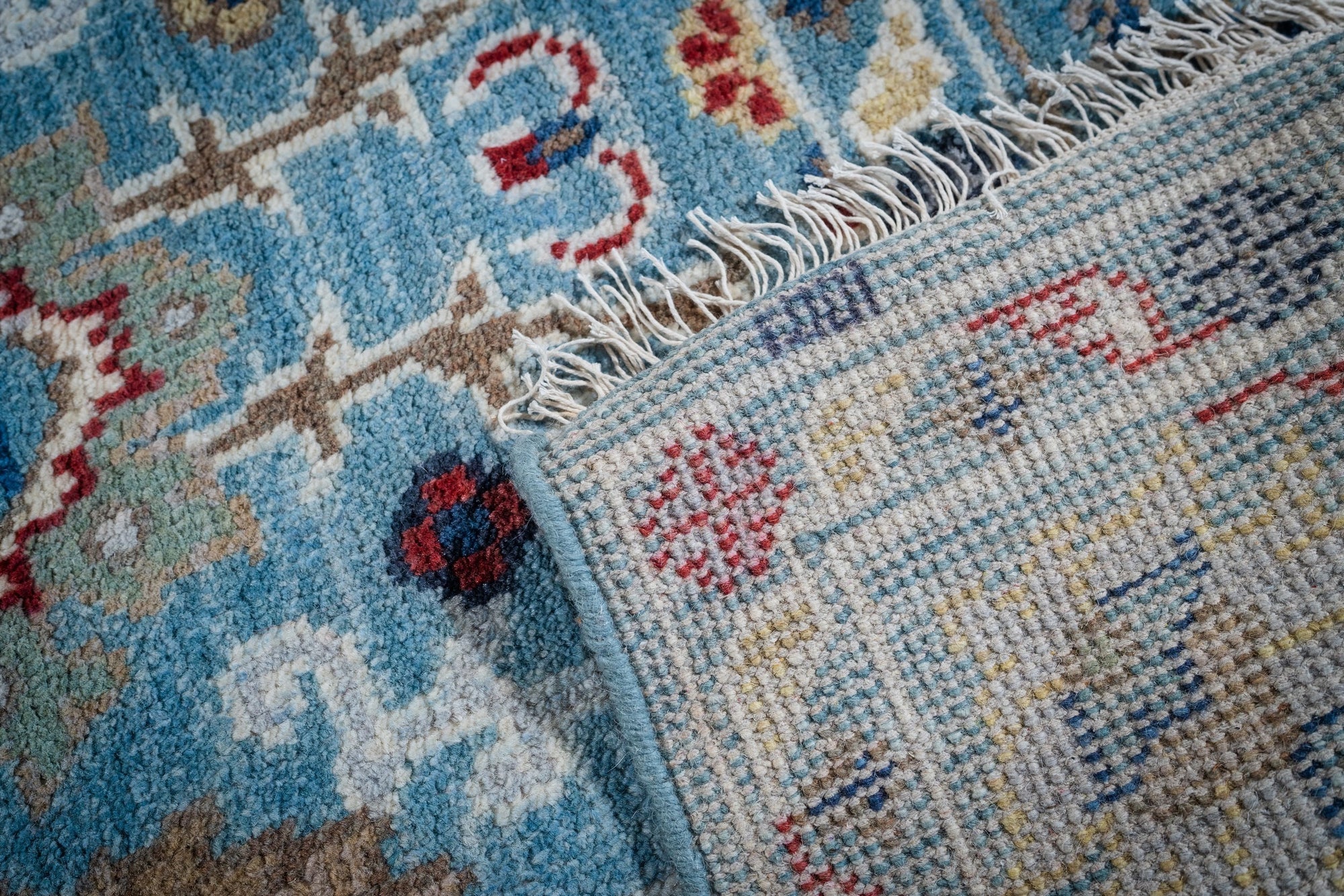 Turquoise Oushak rug back and fringe detail