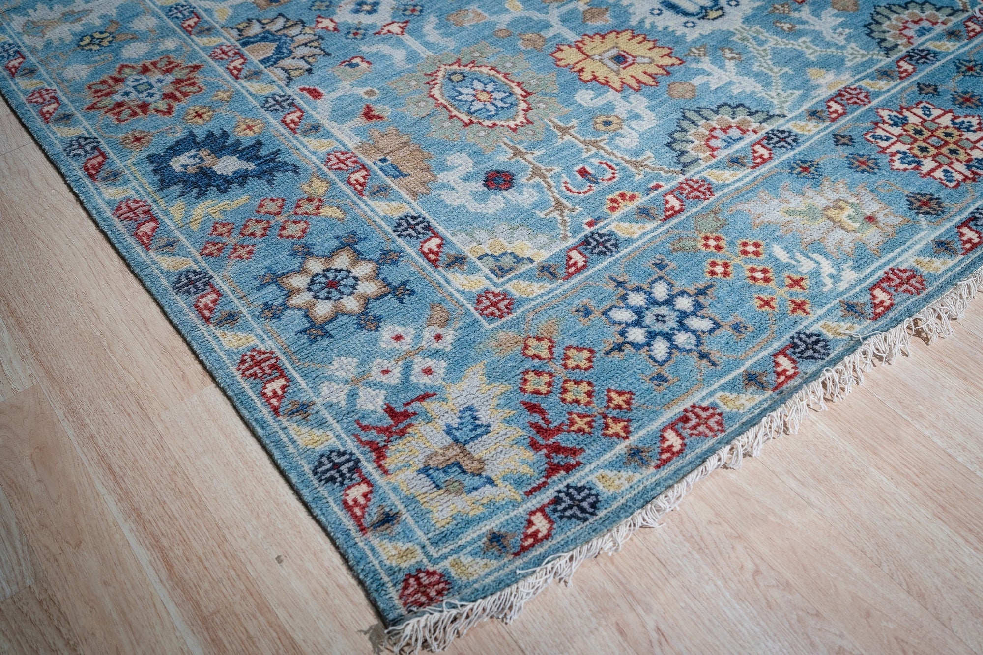 Turquoise Oushak rug corner and fringe detail
