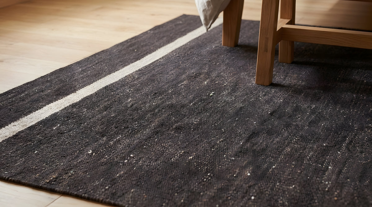 Charcoal Brown Artistic Flatweave Wool Rug in a bedroom