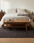 Charcoal Brown Artistic Flatweave Wool Rug in a bedroom