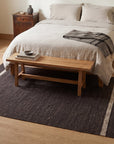 Charcoal Brown Artistic Flatweave Wool Rug in a bedroom