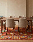 Willow Rust Hand Tufted Wool Rug in a dining room