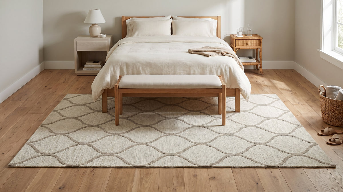 Zinnia Clara Ivory and Light Gold Hand Tufted Wool Rug in a bedroom