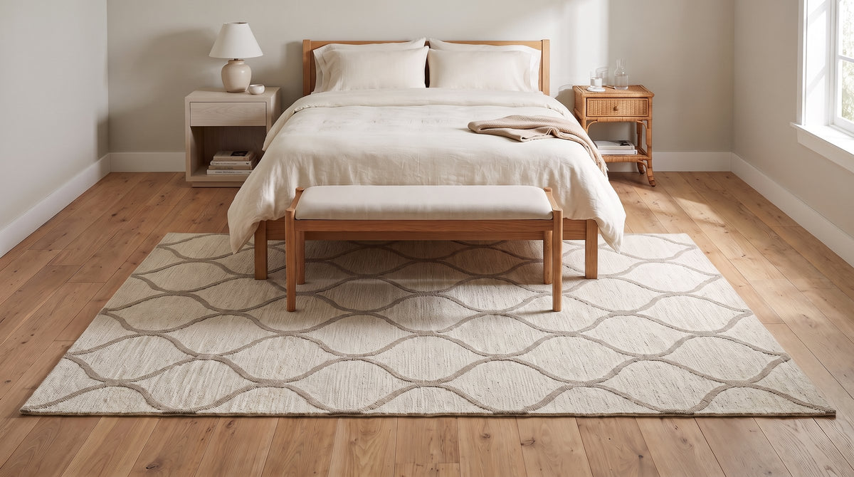 Zinnia Clara Ivory and Light Gold Hand Tufted Wool Rug in a bedroom
